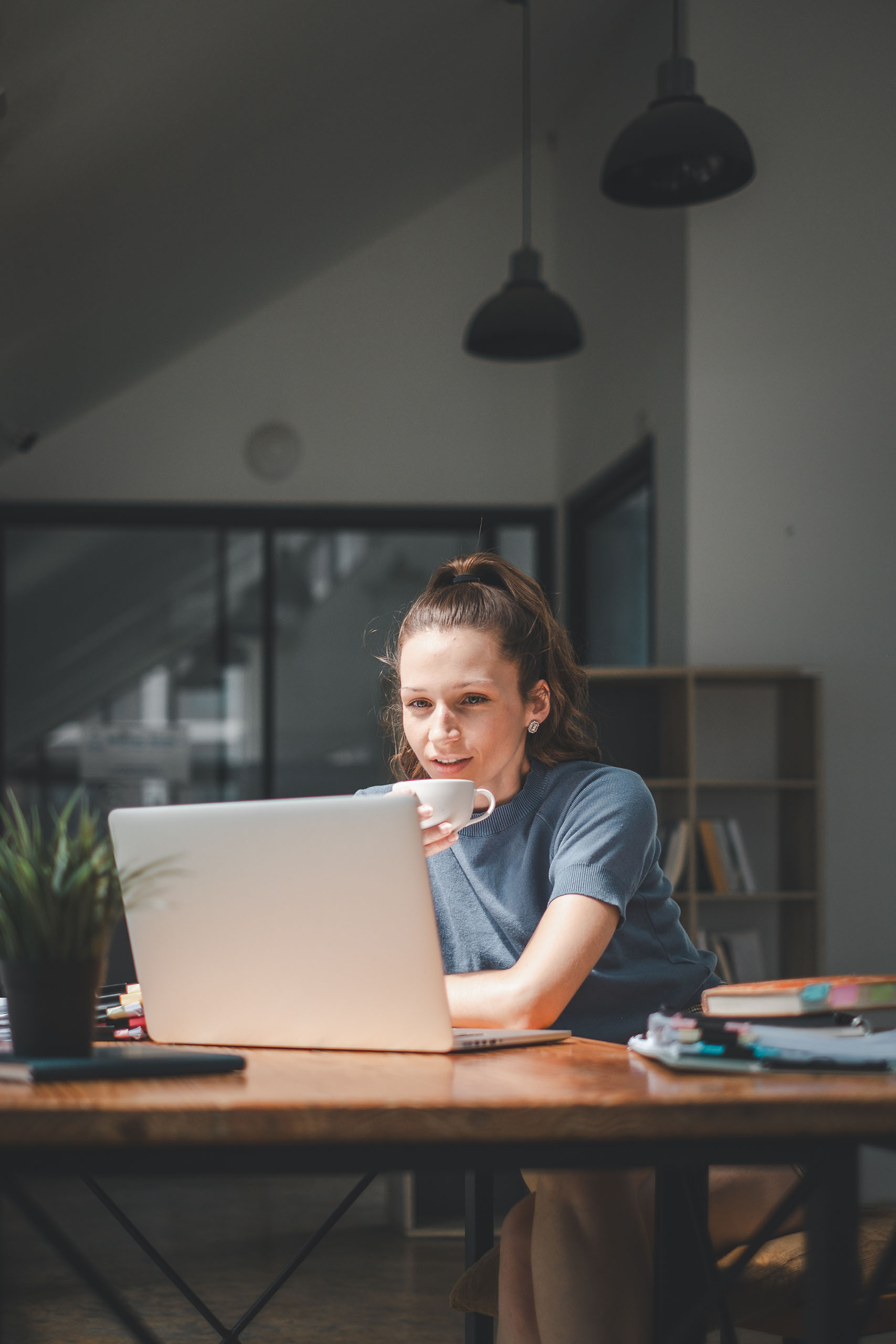 Serious businesswoman using on laptop holding papers preparing r Financial Reporting & Analysis